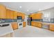 Kitchen with natural wood cabinets, stainless steel appliances, and ample counter space at 2409 Horizon Hike Ct, Raleigh, NC 27603