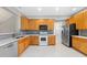 Open concept kitchen boasts stainless steel appliances, a microwave, and ample counter space at 2409 Horizon Hike Ct, Raleigh, NC 27603