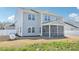 View of back exterior, including fenced yard, vinyl siding, and screened in porch at 254 Arlie Ln, Lillington, NC 27546