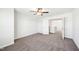 This bedroom features neutral walls and carpet, along with a ceiling fan and an open doorway at 254 Arlie Ln, Lillington, NC 27546