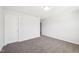 A cozy bedroom features neutral walls, carpeting, and a doorway offering access to other spaces at 254 Arlie Ln, Lillington, NC 27546