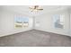 Bright, spacious bedroom featuring plush carpeting, a ceiling fan, and multiple windows at 254 Arlie Ln, Lillington, NC 27546