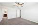 Carpeted bedroom with a ceiling fan, a window, and a doorway leading to a bathroom at 254 Arlie Ln, Lillington, NC 27546