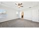 Spacious bedroom features neutral carpeting, a ceiling fan, and large windows at 254 Arlie Ln, Lillington, NC 27546