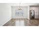 Bright dining room with modern chandelier, adjacent to the kitchen at 254 Arlie Ln, Lillington, NC 27546