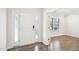 Front entryway of home with hardwood style floors and a white front door at 254 Arlie Ln, Lillington, NC 27546