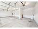 View of a spacious garage interior with a separate door and garage door openers at 254 Arlie Ln, Lillington, NC 27546