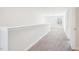 Neutral carpeted hallway with white walls and trim leading to a bright room with a window at 254 Arlie Ln, Lillington, NC 27546