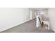 Spacious hallway with neutral carpet leading to other rooms in the home and a view of the fireplace at 254 Arlie Ln, Lillington, NC 27546