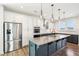 Island kitchen boasts granite countertops, stainless appliances, and pendant lighting at 254 Arlie Ln, Lillington, NC 27546