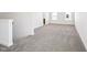 Bright, empty living room space with plush neutral carpet and white walls ready for personalization at 254 Arlie Ln, Lillington, NC 27546