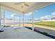 Covered and screened in patio with fan overlooking fenced backyard and grass at 254 Arlie Ln, Lillington, NC 27546