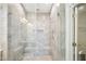 Luxurious walk-in shower with modern tiling, glass enclosure, and dual shower heads at 254 Arlie Ln, Lillington, NC 27546