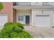 Exterior view featuring attached garage and brick accents at 285 Plaza Dr # C, Chapel Hill, NC 27517