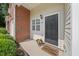 Charming front entrance with brick accent, black door, and welcome mat at 285 Plaza Dr # C, Chapel Hill, NC 27517
