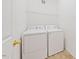 Laundry room featuring modern white appliances, neutral walls, and practical storage solutions at 285 Plaza Dr # C, Chapel Hill, NC 27517