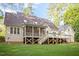 Back of house features a deck, screened porch, and landscaped backyard at 286 Harrison Pond Dr, Pittsboro, NC 27312