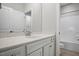 Well-lit bathroom with white cabinets, white walls, and a shower and bath combo at 286 Harrison Pond Dr, Pittsboro, NC 27312