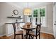 Cozy breakfast nook with natural light and a round wooden table with seating at 286 Harrison Pond Dr, Pittsboro, NC 27312