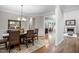 Bright dining room features hardwood floors and a chandelier and is adjacent to the gourmet kitchen at 286 Harrison Pond Dr, Pittsboro, NC 27312