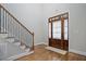 Elegant foyer with hardwood floors, staircase, and a stylish front door creates a grand entrance at 286 Harrison Pond Dr, Pittsboro, NC 27312