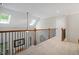 Upstairs hallway with natural light and dark metal banister at 286 Harrison Pond Dr, Pittsboro, NC 27312