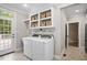 Convenient laundry room with washer, dryer, storage, and backyard access at 286 Harrison Pond Dr, Pittsboro, NC 27312