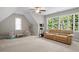 Cozy living room with large windows providing natural light and a comfortable seating area at 286 Harrison Pond Dr, Pittsboro, NC 27312
