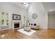 Spacious living room with hardwood floors, a fireplace, and abundant natural light creates a cozy ambiance at 286 Harrison Pond Dr, Pittsboro, NC 27312