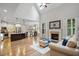 Open-concept living room features high ceilings, a fireplace, and seamless flow to the gourmet kitchen at 286 Harrison Pond Dr, Pittsboro, NC 27312