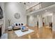Cozy living space adjacent to entry features hardwood floors, a high ceiling, and staircase at 286 Harrison Pond Dr, Pittsboro, NC 27312