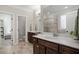 Main bathroom showcasing double vanities, marble countertops, and a glass-enclosed shower at 286 Harrison Pond Dr, Pittsboro, NC 27312