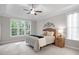 Tranquil main bedroom featuring a tray ceiling, large windows, and neutral tones at 286 Harrison Pond Dr, Pittsboro, NC 27312
