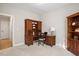 Bright office space with wood desk, shelving, drawers, and comfortable chair at 286 Harrison Pond Dr, Pittsboro, NC 27312
