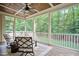 Inviting screened porch features wooded views, a ceiling fan, and comfortable seating, perfect for relaxing outdoors at 286 Harrison Pond Dr, Pittsboro, NC 27312