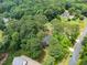 Aerial view of a home nestled among lush trees in a wooded neighborhood at 2968 Tram Rd, Fuquay Varina, NC 27526
