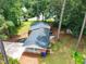 Aerial view of a brick home with a covered carport surrounded by lush trees at 2968 Tram Rd, Fuquay Varina, NC 27526
