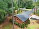 Aerial view of a brick home with green landscaping, mature trees, and a long driveway at 2968 Tram Rd, Fuquay Varina, NC 27526