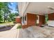 Wide, open carport, built of brick with a white painted ceiling, and views to the landscape at 2968 Tram Rd, Fuquay Varina, NC 27526