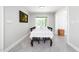 Dining room with large window, dining table with six chairs, herringbone tile floor, and neutral color palette at 2968 Tram Rd, Fuquay Varina, NC 27526