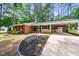 Inviting brick home with a covered carport and manicured landscaping at 2968 Tram Rd, Fuquay Varina, NC 27526