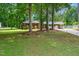 A charming brick home nestled among mature trees with a lush green lawn at 2968 Tram Rd, Fuquay Varina, NC 27526