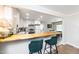 Kitchen with breakfast bar featuring butcher block countertop and seating, opening to the dining and living area at 2968 Tram Rd, Fuquay Varina, NC 27526