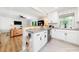 White kitchen features butcher block and concrete countertops, stainless steel appliances, and herringbone tile floors at 2968 Tram Rd, Fuquay Varina, NC 27526