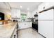 Bright kitchen with stainless steel oven and white appliances, white subway tile backsplash, and tiled floors at 2968 Tram Rd, Fuquay Varina, NC 27526