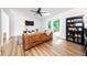 Bright living room with a shiplap wall, hardwood flooring and outdoor views at 2968 Tram Rd, Fuquay Varina, NC 27526