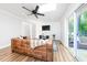 Spacious living room with a skylight, shiplap wall, and modern decor at 2968 Tram Rd, Fuquay Varina, NC 27526