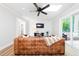 Bright living room featuring a modern ceiling fan, shiplap wall and skylight at 2968 Tram Rd, Fuquay Varina, NC 27526