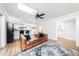 Open floor plan with living room, kitchen featuring hardwood floors and skylight at 2968 Tram Rd, Fuquay Varina, NC 27526