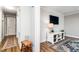 Hallway view to a stylish living room with shiplap wall and a decorative rug at 2968 Tram Rd, Fuquay Varina, NC 27526